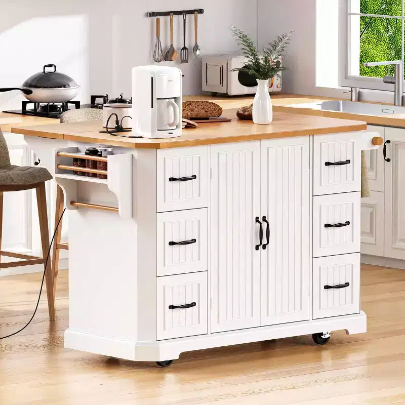 Isola da Cucina Bianca 56" Impiallacciatura in Legno di Gomma, Ribaltina, Presa di Corrente, 4 Ante, Ripiani, 6 Cassetti Profondi, Carrello Rotante