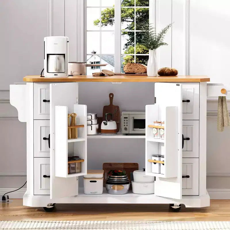 Isola da Cucina Bianca 56" Impiallacciatura in Legno di Gomma, Ribaltina, Presa di Corrente, 4 Ante, Ripiani, 6 Cassetti Profondi, Carrello Rotante